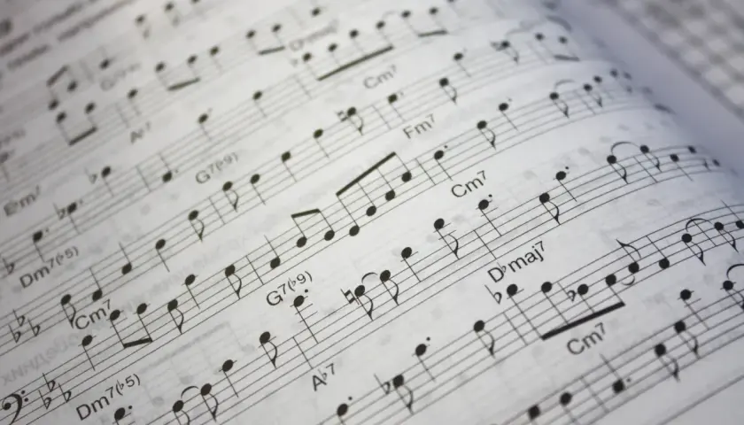 Partition musicale avec des notes et des accords, suggérant une transposition pour saxophone alto.