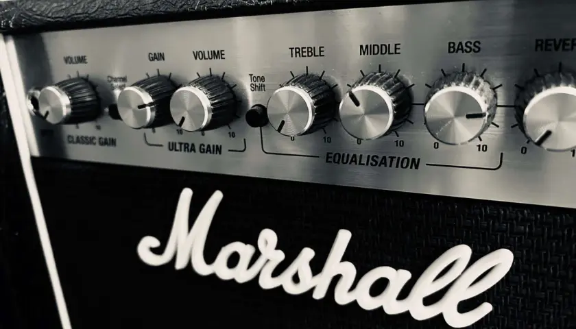 Gros plan sur le panneau de contrôle d'un ampli Marshall, avec les boutons de réglage du son (Volume, Gain, Treble, Middle, Bass) et le logo emblématique.
