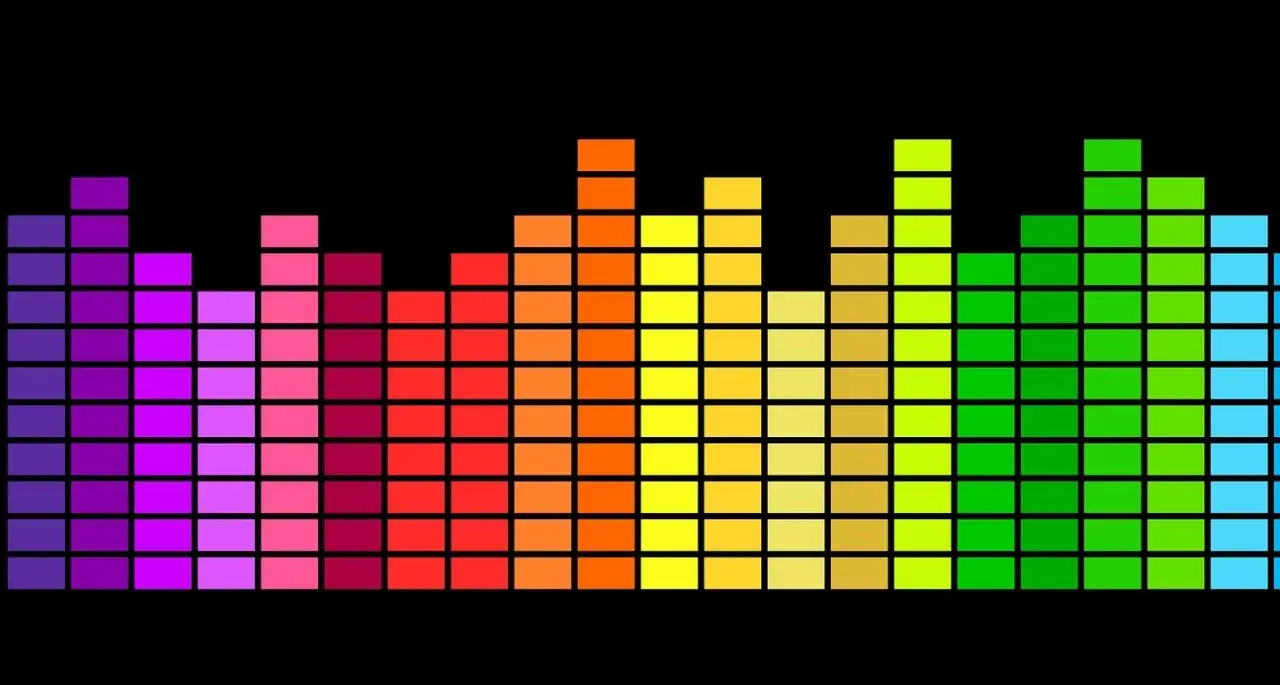 Un **égaliseur musique** arc-en-ciel sur fond noir, avec des barres de différentes hauteurs représentant les fréquences sonores.